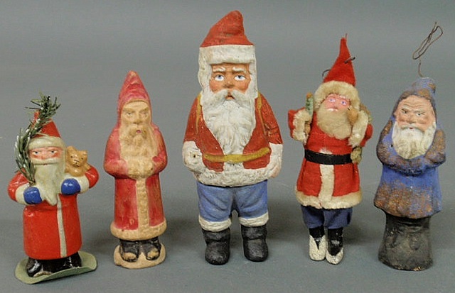 Appraisal: Five Christmas Santa figures incl a papier-m ch Belsnickle candy