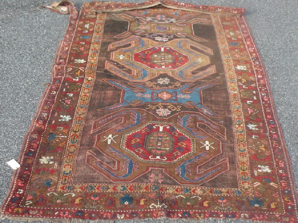 Appraisal: A Persian rug with three medallions on a brown ground