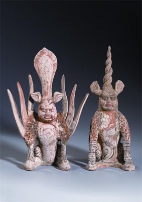 Appraisal: A pair of Chinese unglazed pottery models of earth spirits