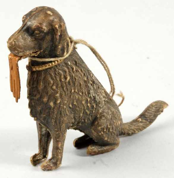 Appraisal: German Dresden Sitting Dog Christmas Ornament Description Dog with glove