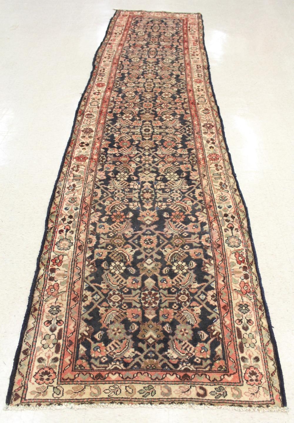 Appraisal: HAND KNOTTED PERSIAN HALL RUG overall Herati floral design on