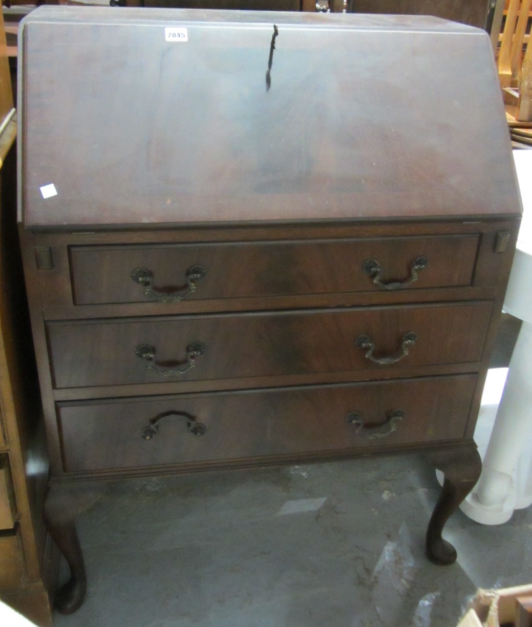 Appraisal: A th century mahogany bureau with three long drawers and