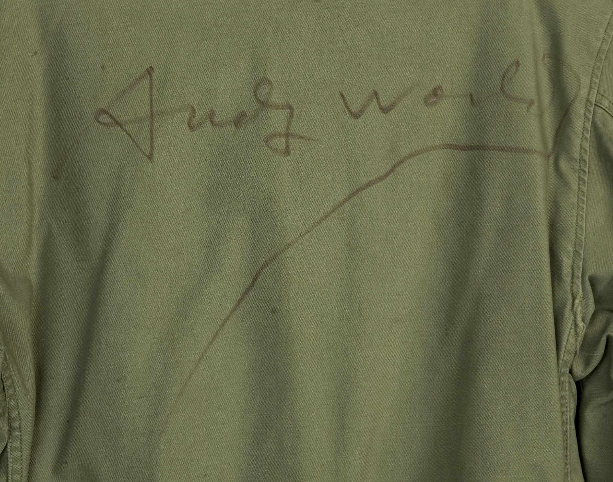 Appraisal: An Andy Warhol signed jacket An olive-green Army jacket signed