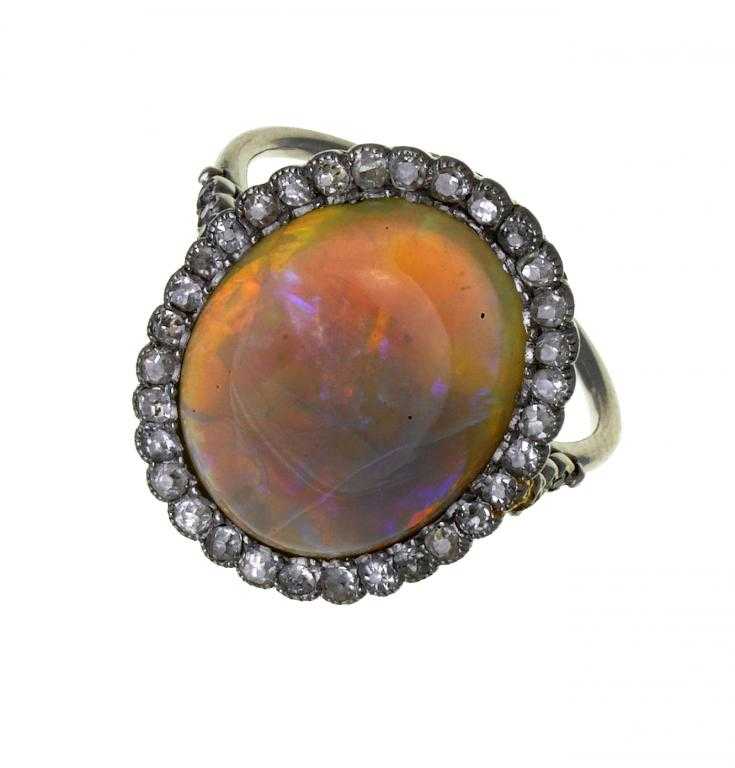 Appraisal: AN OPAL AND DIAMOND RING the oval opal surrounded by