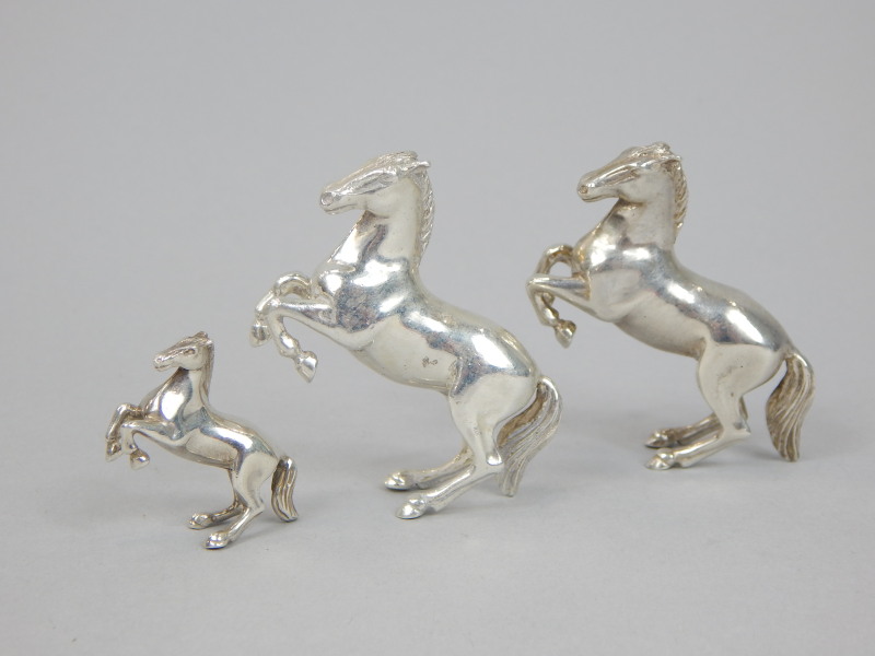 Appraisal: Three various white metal figures of horses comprising of a