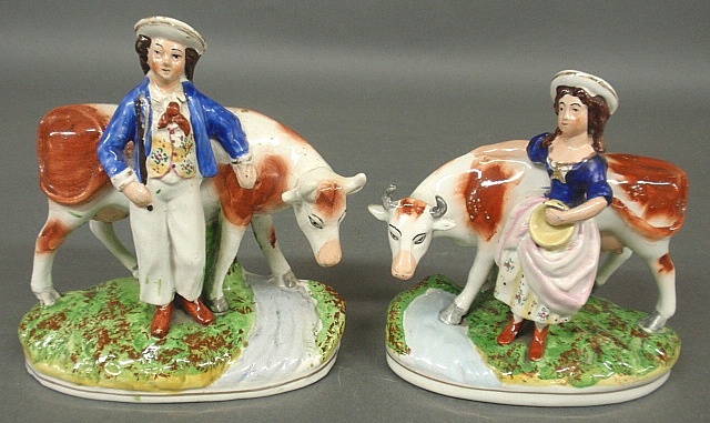 Appraisal: - Pair of Staffordshire figural groups of a milkmaid and