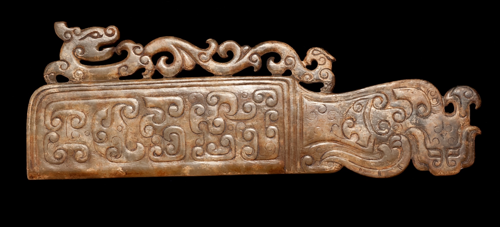 Appraisal: BROWN JADE CARVING In archaic style with openwork dragon carving