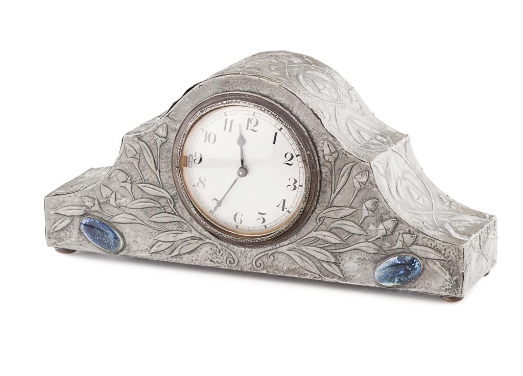 Appraisal: ARTS CRAFTS PEWTER MANTEL CLOCK CIRCA repouss decorated with flowering