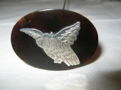 Appraisal: A SILVER AND TORTOISESHELL HAT PIN the oval top inlaid