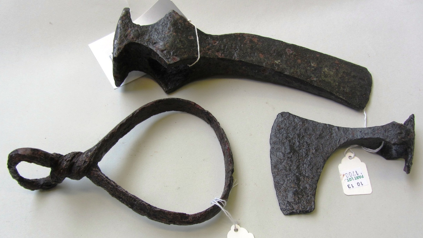 Appraisal: Two Viking iron axe heads and an iron Viking stirrup