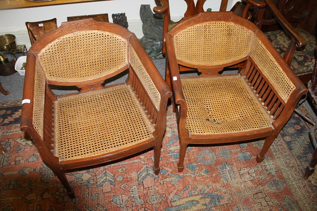 Appraisal: A PAIR OF MAHOGANY BERGERE ARMCHAIRS each on tapering supports