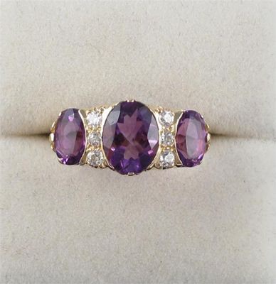 Appraisal: An amethyst and diamond ring Set with three graduated oval