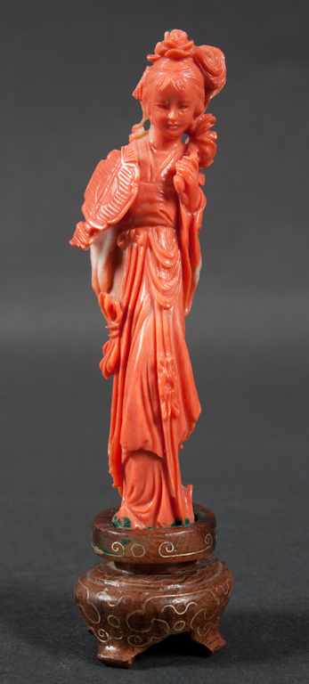 Appraisal: Chinese carved coral figure of a deity figure holding flowers