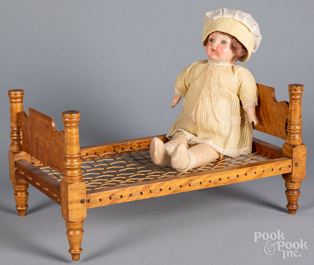 Appraisal: Maple doll bed together with a painted doll Maple doll