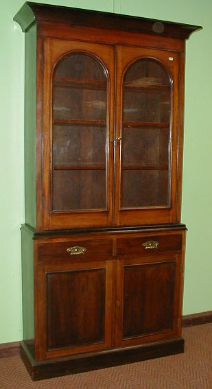 Appraisal: A Victorian mahogany bookcase with moulded cornice over two arch