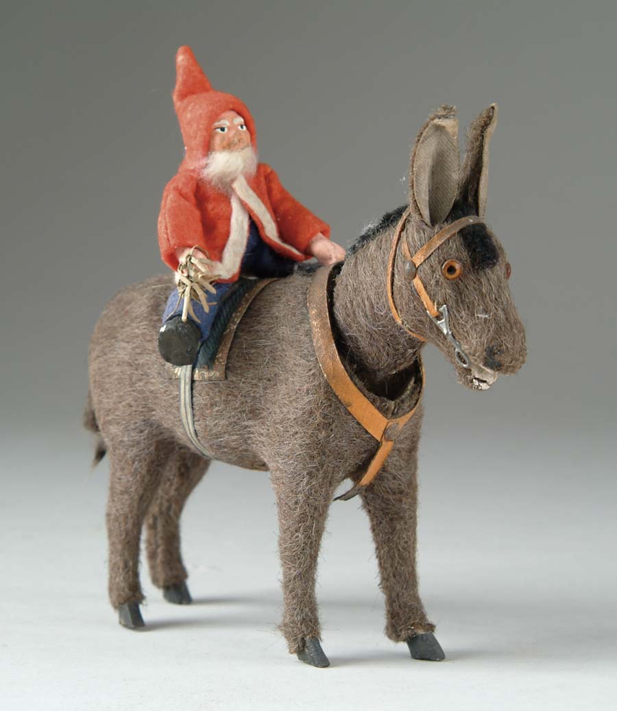 Appraisal: SANTA ON NODDING DONKEY Felt-dressed paper mache Santa with feather