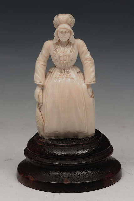 Appraisal: A CONTINENTAL IVORY MINIATURE FIGURE OF A FLEMISH WOMAN in