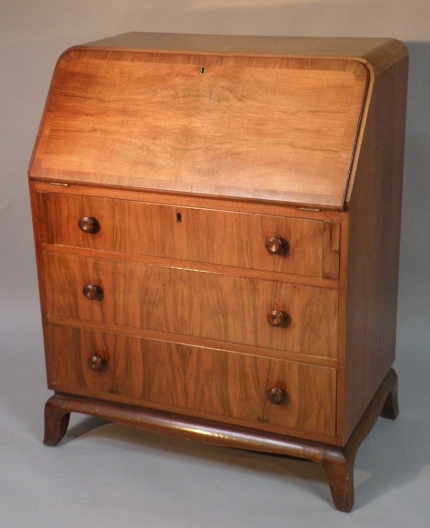 Appraisal: A mid- thC walnut finish bureau the half veneered fall