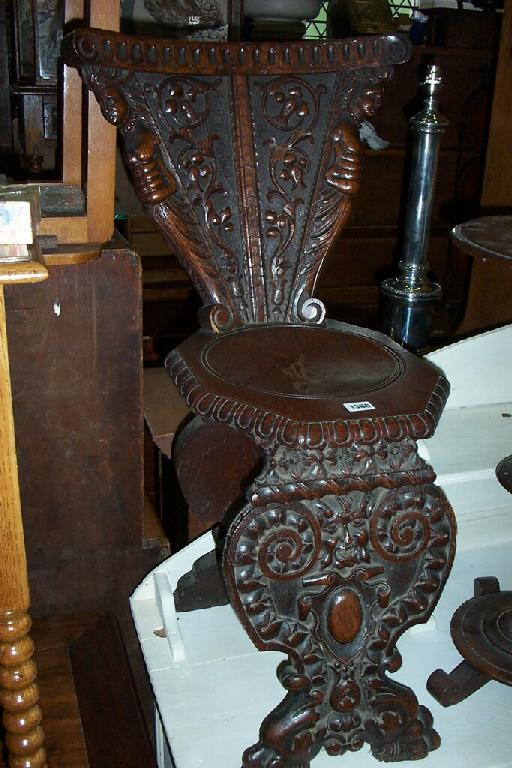 Appraisal: A Victorian oak hall chair the shaped back with well