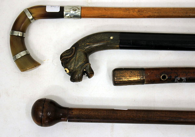 Appraisal: FOUR ANTIQUE WALKING STICKS to include an ebony walking cane