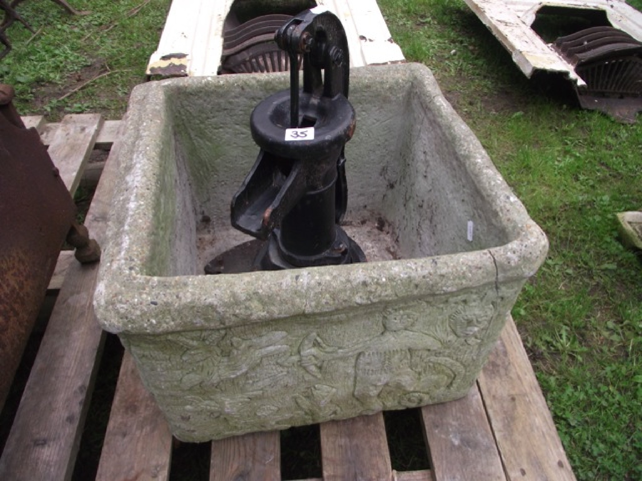 Appraisal: A weathered cast composition stone planter of square cut form