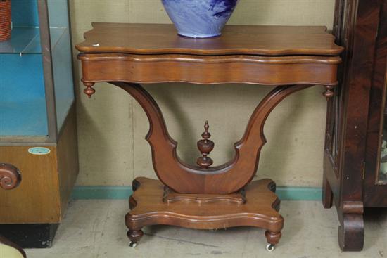 Appraisal: TILT TOP GAME TABLE Walnut having a shaped top conforming