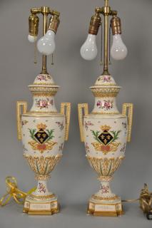 Appraisal: Pair of French porcelain hand painted urns made into table