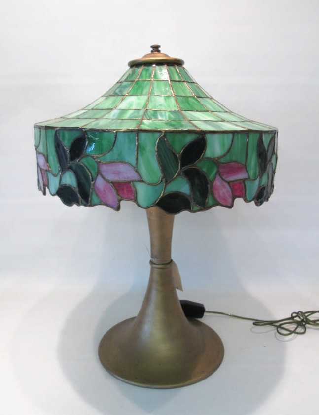 Appraisal: SLAG AND STAINED GLASS TABLE LAMP the shade having multi-paneled