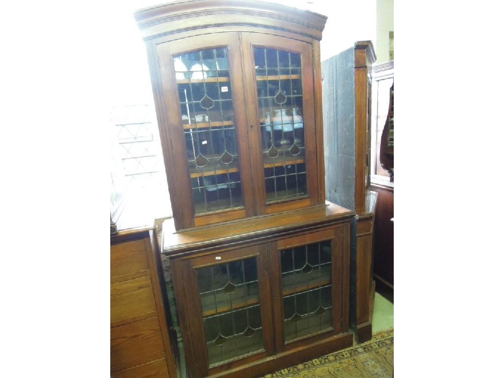 Appraisal: An Edwardian walnut two sectional bookcase enclosed by two pairs