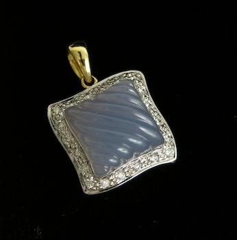 Appraisal: A Carved Chalcedony and Diamond Pendant k yellow gold undulating