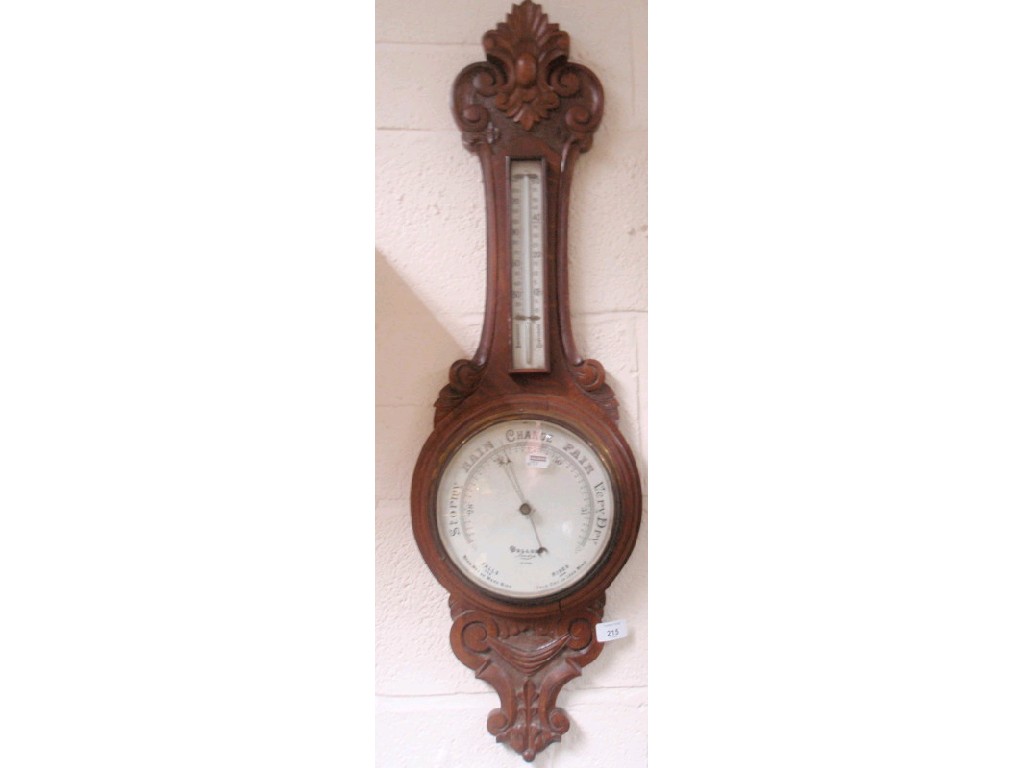 Appraisal: An Edwardian carved oak aneroid wheel barometer with cartouche and