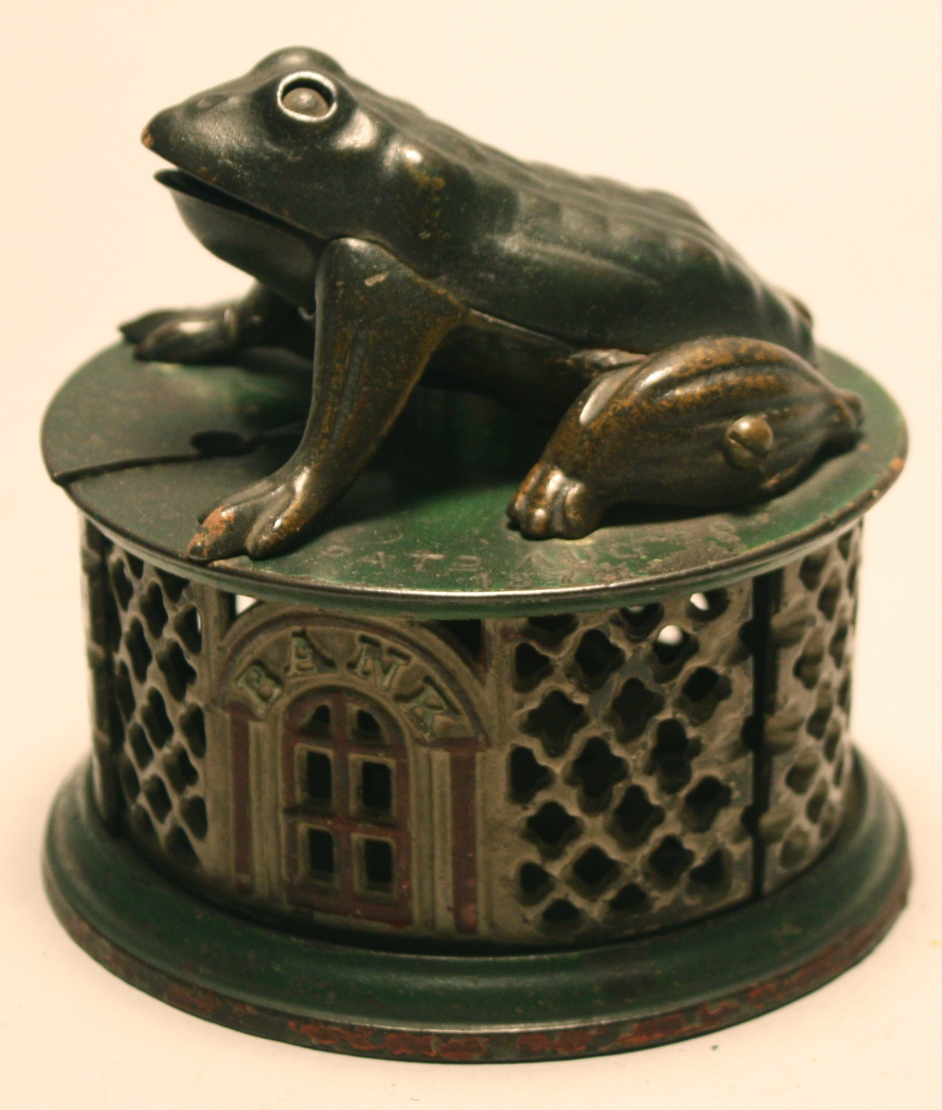 Appraisal: J E STEVENS CO FROG ON LATTICE MECHANICAL BANK With