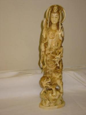 Appraisal: A JAPANESE CARVED IVORY OKIMONO of Nannon riding on a