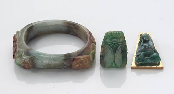 Appraisal: A collection of jade jewelry featuring a carved bangle ring