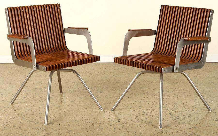 Appraisal: UNUSUAL PAIR TEAK AND STEEL SLATTED ARM CHAIRS An unusual