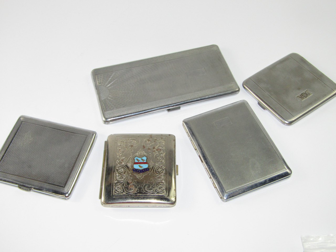 Appraisal: Five chrome or plated pocket cigarette cases with engraved foliate