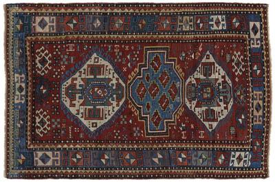 Appraisal: Kazak rug three central medallions on brick red field green