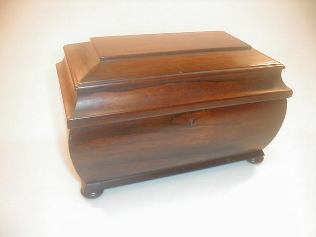 Appraisal: An early Victorian rosewood tea caddy of rounded sarcophagus form