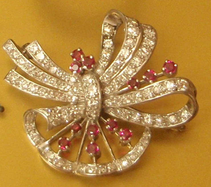 Appraisal: A ruby and diamond spray brooch in the form of