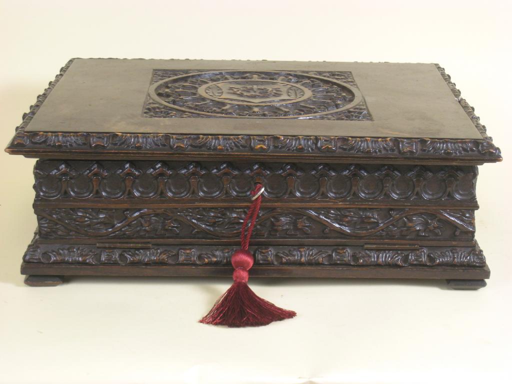 Appraisal: A carved walnut Gothic Bible Box the hinged cover carved