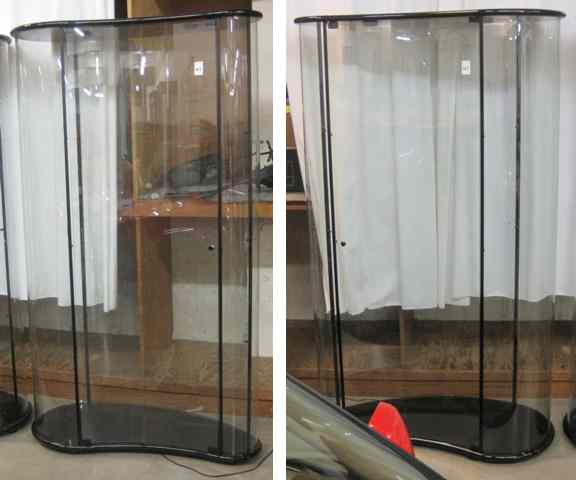 Appraisal: A PAIR OF CONTEMPORARY CURVED GLASS CURIO CABINETS each a