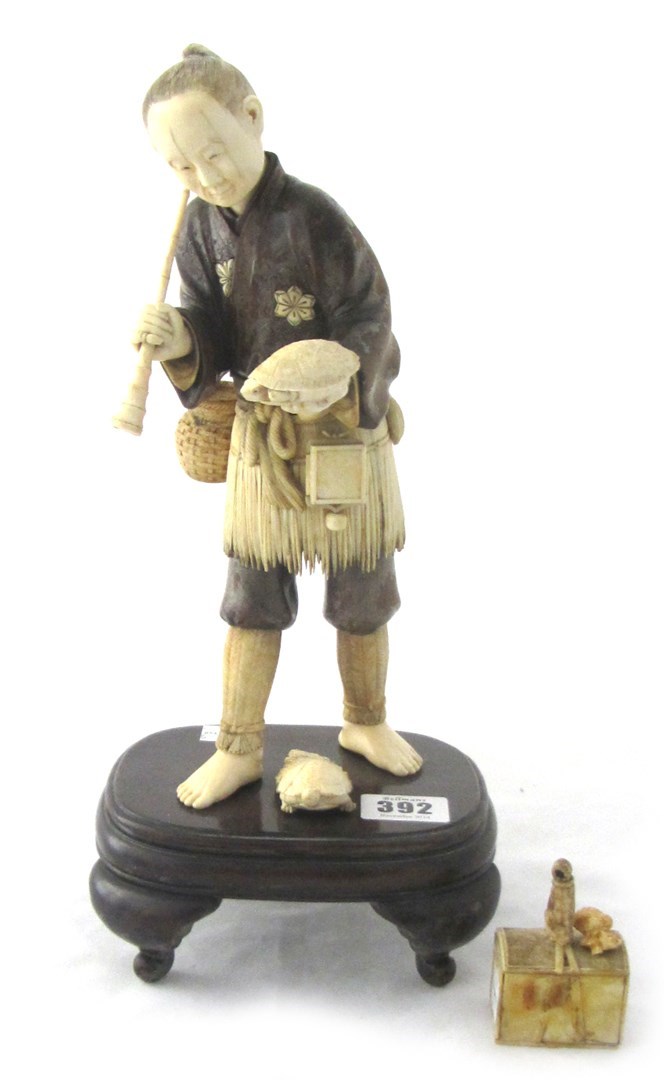 Appraisal: A Japanese sectional wood and ivory figure of a fisherman