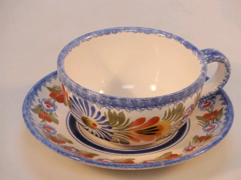 Appraisal: A modern Quimper cup and saucer polychrome painted with flowers