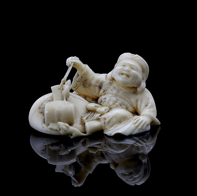 Appraisal: A Japanese ivory netsukelate th Centurymodelled as a seated Daikoku