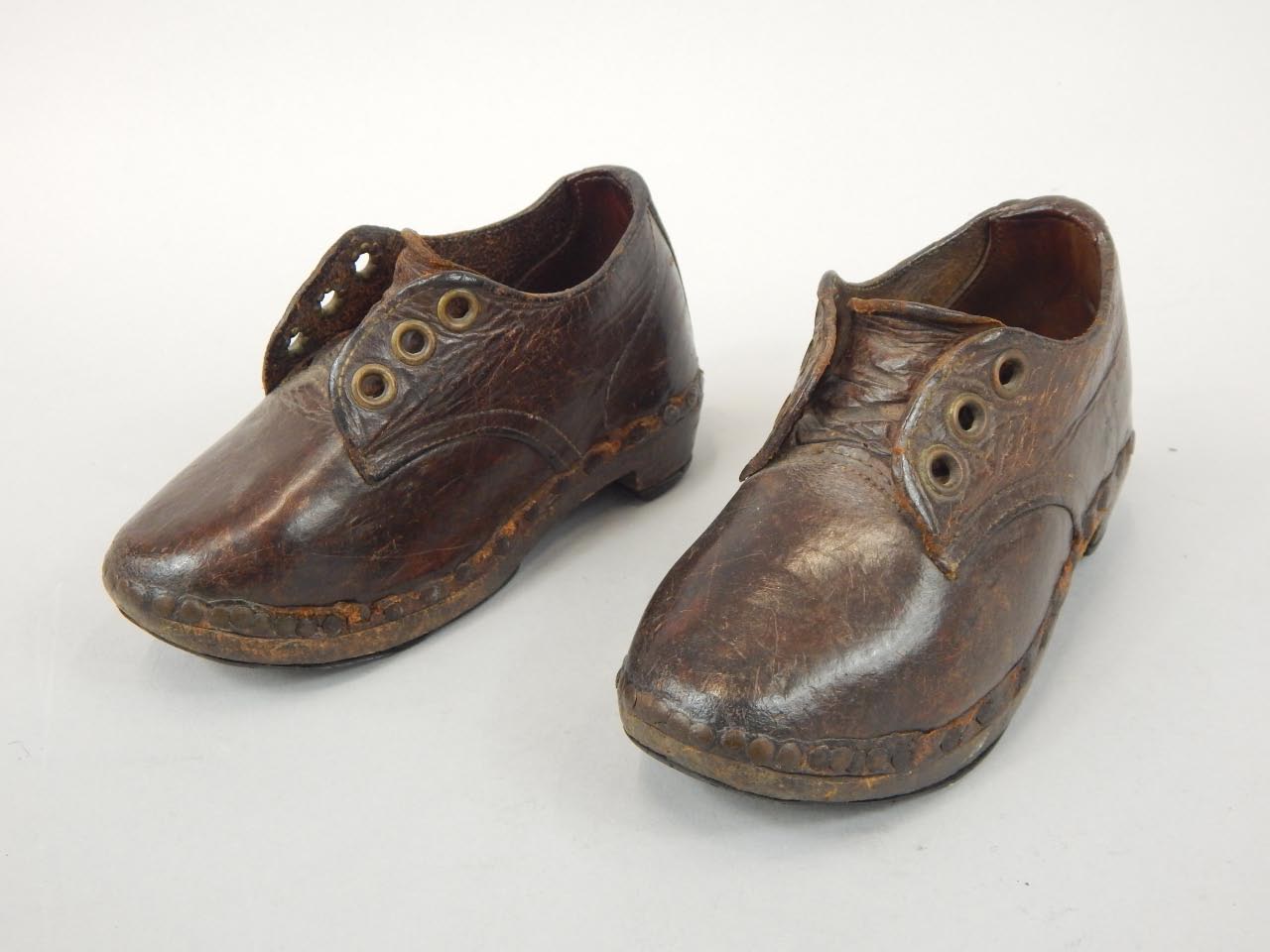 Appraisal: A pair of Victorian leather child's shoes with heavy hammered