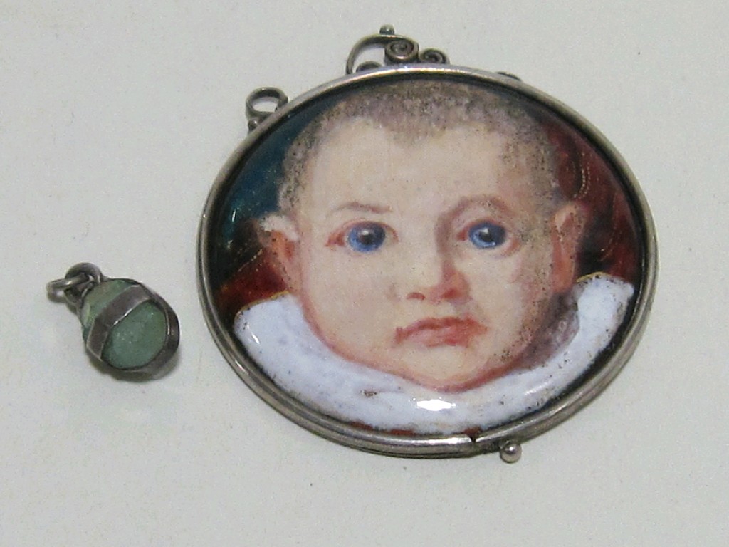 Appraisal: Arts Crafts silver and enamel circular pendant depicting a baby's