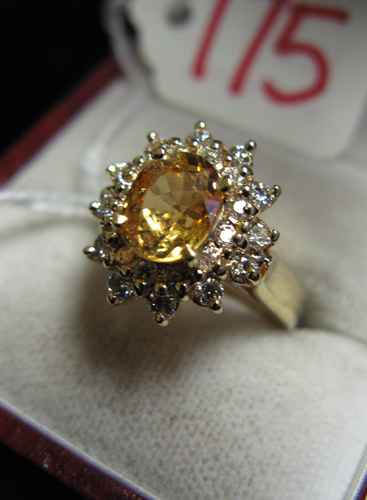 Appraisal: YELLOW SAPPHIRE DIAMOND AND FOURTEEN KARAT GOLD RING centering an