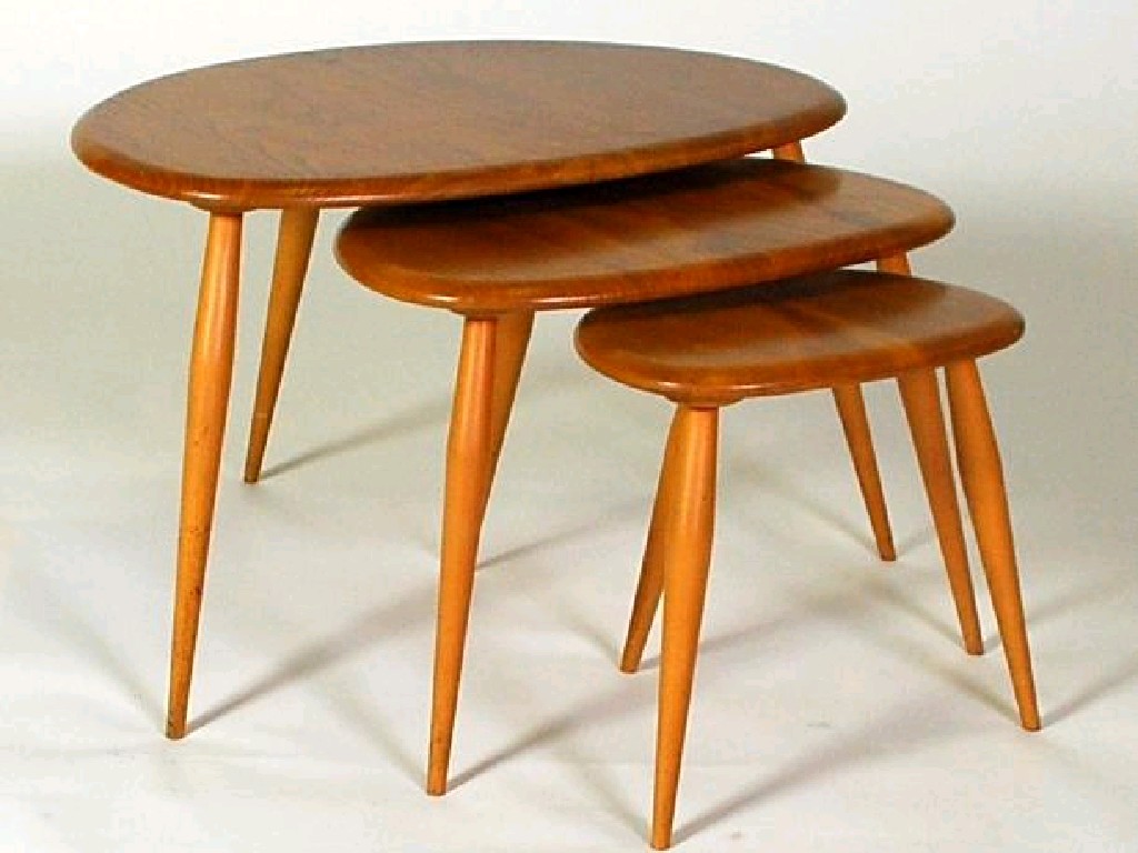 Appraisal: NEST OF THREE ERCOL OCCASIONAL TABLES with shaped oval tops