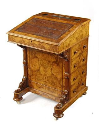 Appraisal: A Victorian walnut Davenport fitted with four drawers and on