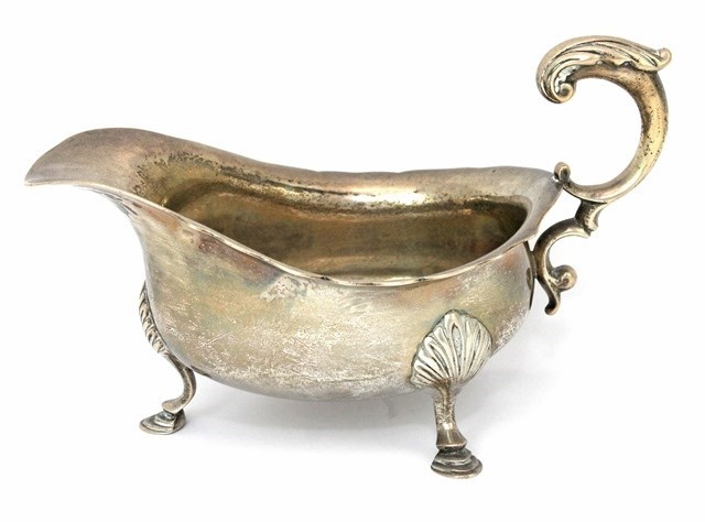 Appraisal: A silver large sauceboat decorated with a wavy rim having